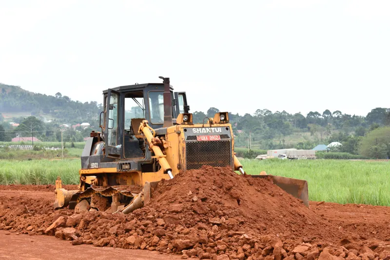 A Shantui bulldozer pushing red murram in Uganda