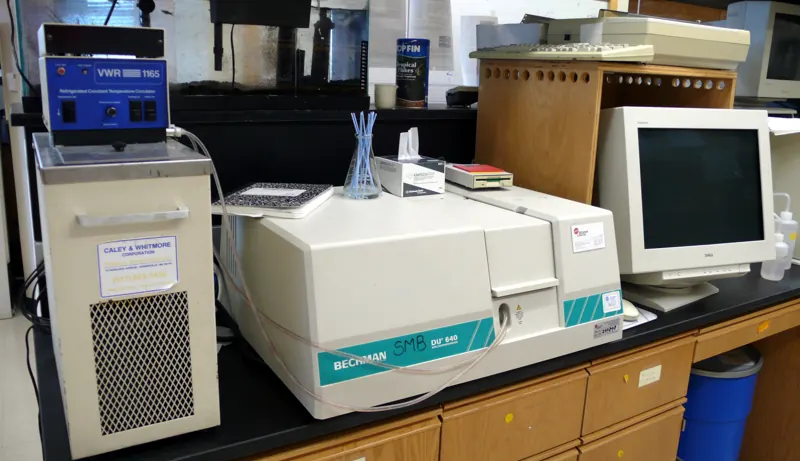 Laboratory analysers and a spectrophotometer on a lab bench